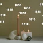 Candles burning with eggs and the number 1818 all around it.
