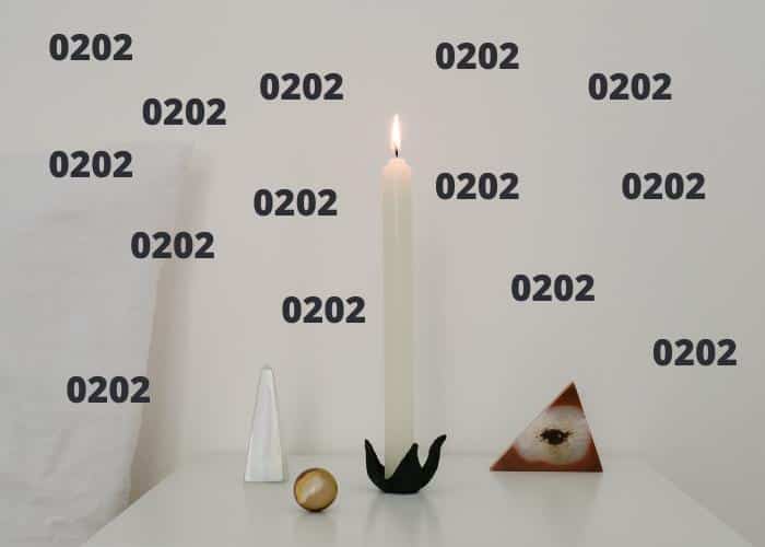 Image of candle burning on bedstand with a bunch of 0202 numbers floating around it